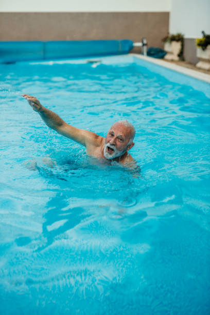istock Senior man in the pool 1454946476