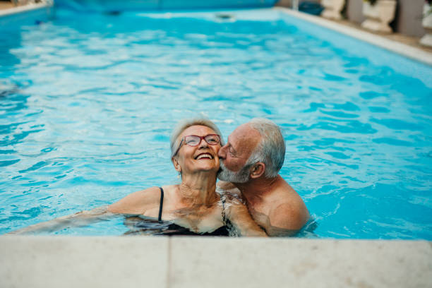 istock Senior couple in the pool 1454946491