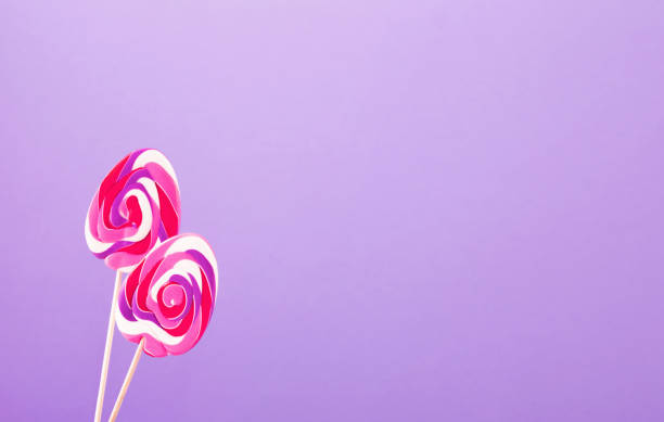 easter candy canes in  form of eggs on purple background