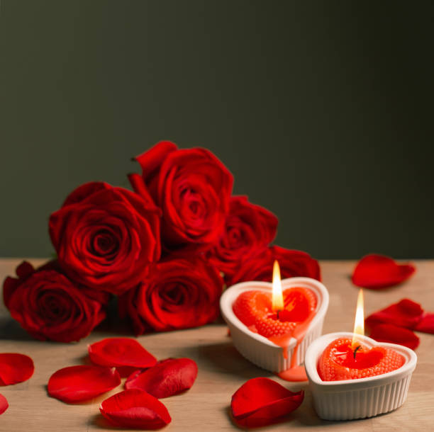 istock red roses with burning candles on dark background 1454946741
