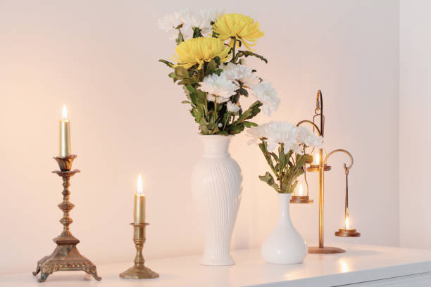 istock chrysanthemums flowers in vases and burning candles on white interior 1454946774