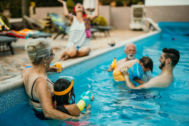 istock Family enjoying in swimming pool 1454946879