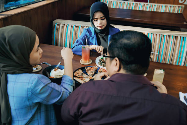 istock asian employees taking lunch in the restaurant 1454952947