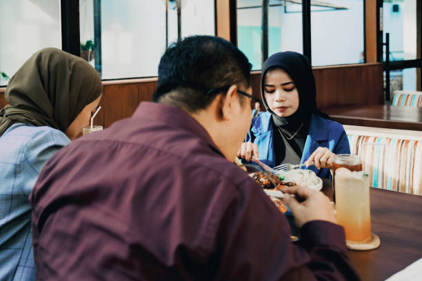 istock asian employees taking lunch in the restaurant 1454952954