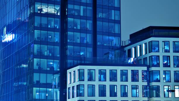 istock Pattern of office buildings windows illuminated at night. 1454956220