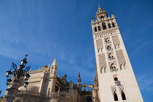 A low-angle shot of the Giralda, the bell tower of Seville Cathedral in Seville, Spain.