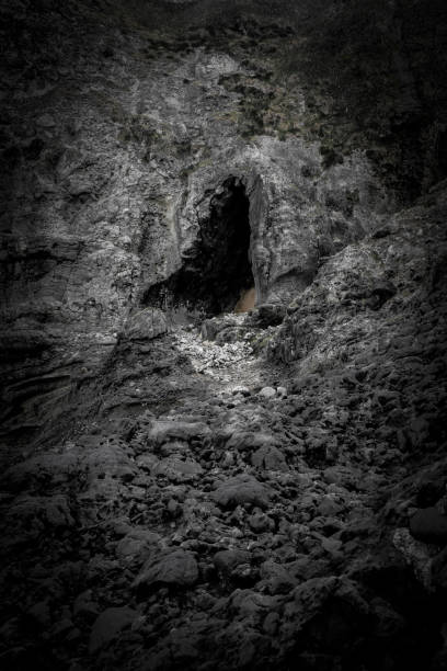 istock Vertical grayscale shot of the cave on the cliff. 1454957631