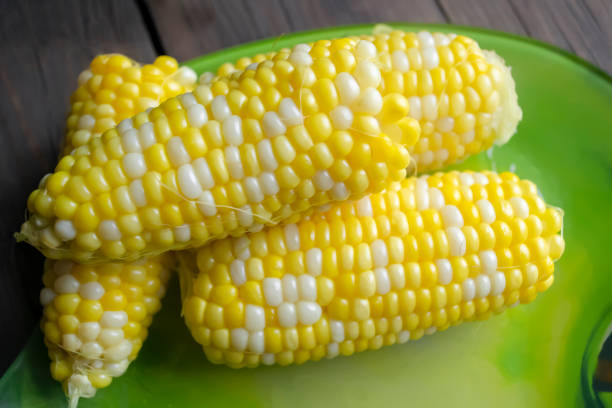 istock Boiled corn on a plate. Cobs of kuuruza with colored grains. The finished corn is on a plate for food. 1454957796