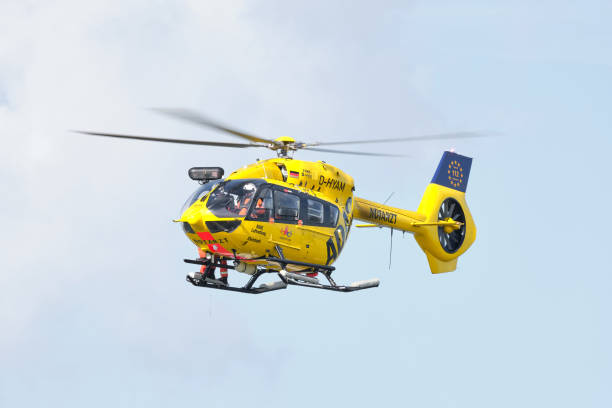 ADAC rescue helicopter hovering in the air for an exercise Wilhelmshaven, Germany – September 28, 2021: ADAC rescue helicopter hovering in the air for an exercise at the North Sea coast. adac stock pictures, royalty-free photos & images