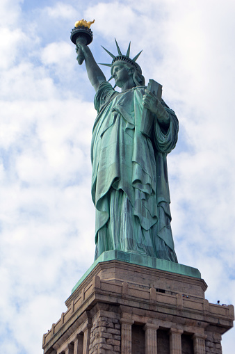 A vertical shot of the Statue of Liberty in New York City, in the United States