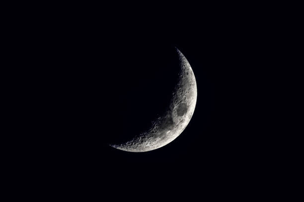 new moon in a black sky in detail Close-up horizontal view of a new moon in a black sky in detail sliver stock pictures, royalty-free photos & images