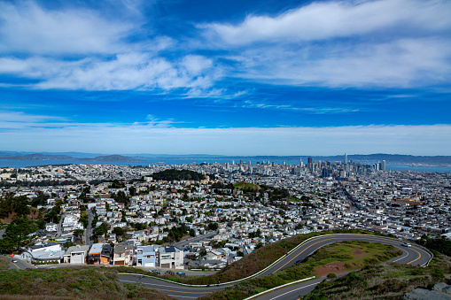 An aerial view of twin peaks park under a blue sky with clouds
