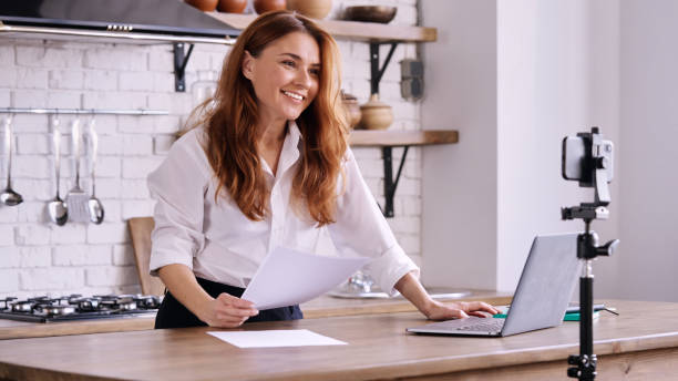 istock Caucasian female making an instructional video in a modern kitchen 1454964446