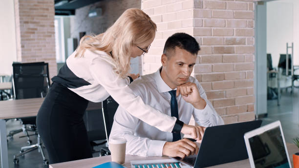 istock Caucasian female explaining office rules to a newcomer in the office 1454964467