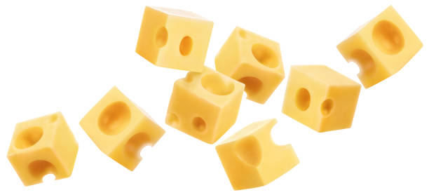 istock Flying cubic pieces of delicious cheese on white 1454965537