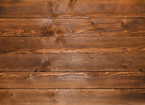 A wall of horizontal boards. brown wood panels.