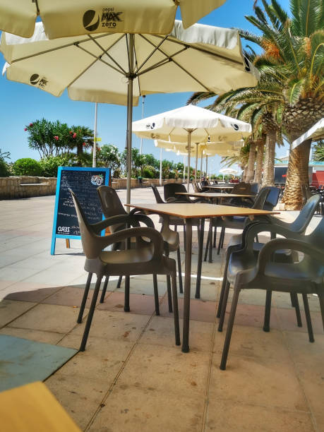 istock Madrid, Spain; 09-06-2022: tables on a terrace on a promenade 1454967241
