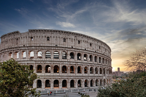 roma, Italy – March 28, 2022: The iconic Colosseum in Rome against a scenic sunset skies background