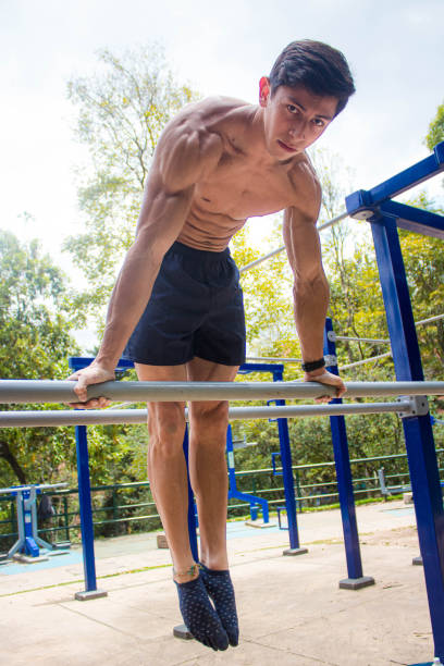 istock Young shirtless athletic man exercising in a park 1454968520