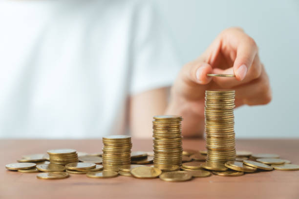 istock Hand putting coins on stack on table. concept saving money and financial growth. 1454968895