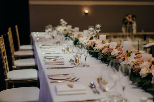 istock Beautifully arranged long table at a wedding venue with floral decorations 1454969130