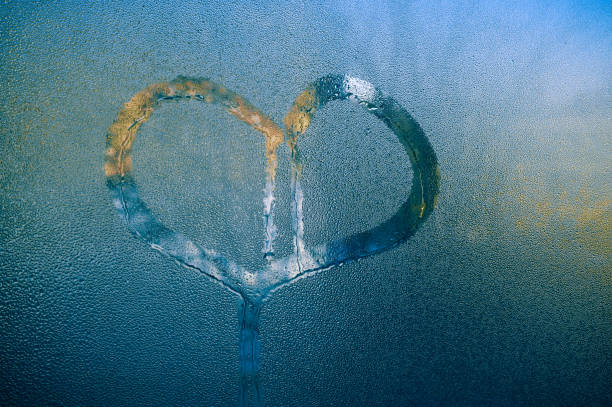istock the heart is painted on wet glass. 1454969876