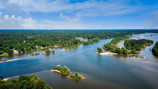 An aerial view of a lake with green landscapes in Houston, Texas