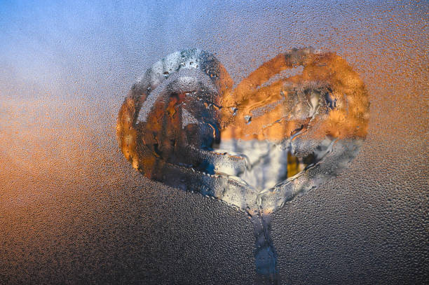 A heart painted on fogged glass. Multicolored background