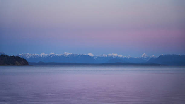 istock Twilight on the ocean.  The pink sky reflected in the calm ocean 1454971194