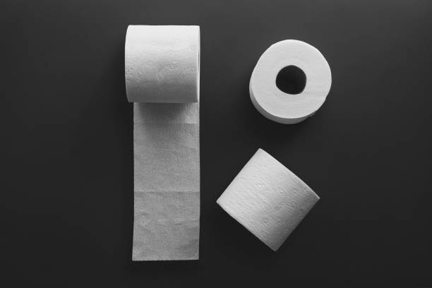 istock Top view of toilet paper rolls on a black background 1454971801