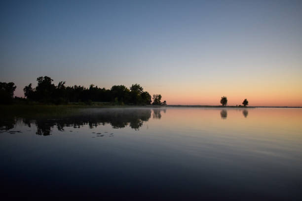 istock Mesmerizing view of trees with reflection in a lake during susnet in Montreal, Canada 1454972139