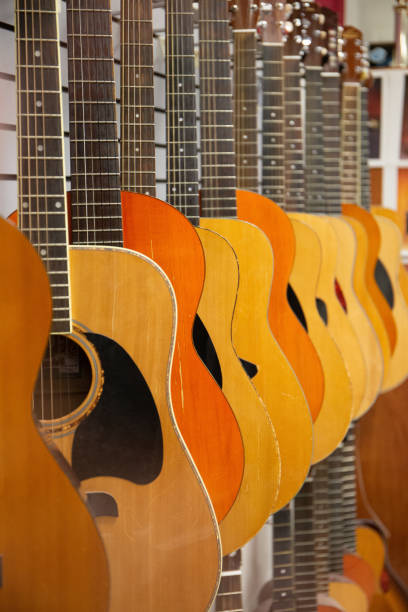 istock Line of hanging guitars 1454972634