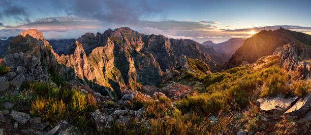 Mountain landscpape panorama at sunrise over clouds in Madeira Island, Pico Arieiro, Portugal stock photo