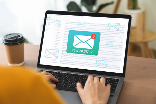istock Businessman hand using computer laptop and shows a digital screen of new email notifications. 1454977912