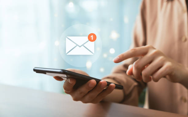 istock Hand holding smartphone and shows a digital screen of new email notifications. 1454977936