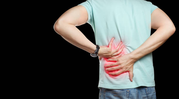 istock Man suffering from a lower back pain on black 1454978838