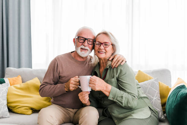 istock Senior retired couple drinking tea and enjoy talking conversation together on sofa with happiness laugh smile and joyful at home 1454980257