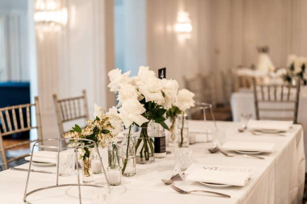 istock Table decorated with beautiful white flowers and candles on a wedding party 1454980441