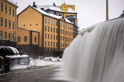 The river Motala Ström (Strömmen) by old industrial buildings, a landmark of Norrköping, Sweden
