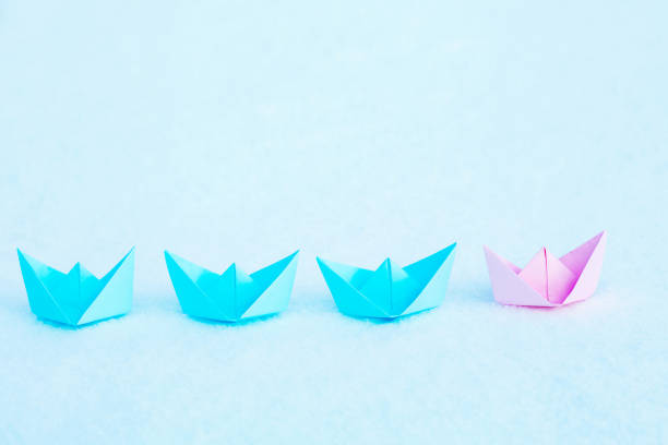 istock Red paper ship leading among blue ships. Leadership concept. 1454980700