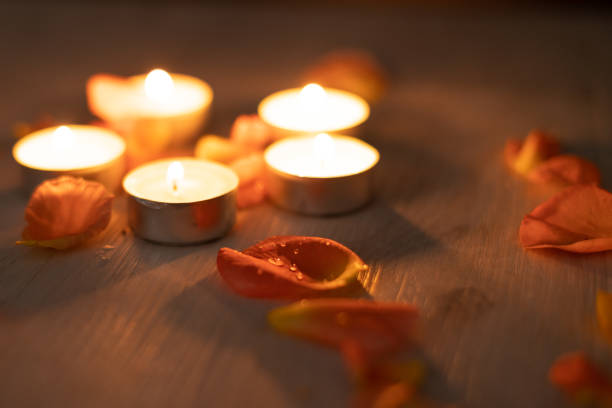 istock Rose petals and a set of scented candles, a romantic evening. 1454981267