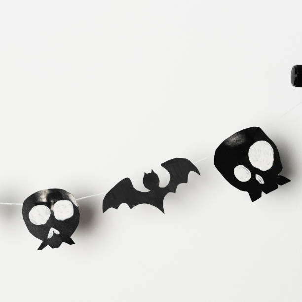 istock Bats and skulls black on white background, place to write greeting. 1454981355