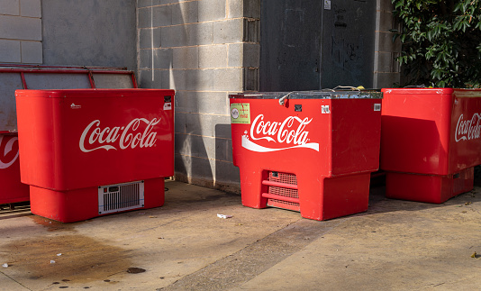 Felanitx, Spain; december 30 2022: Industrial bar coolers with the logo of the international soft drink brand Coca Cola, outside on a sunny day