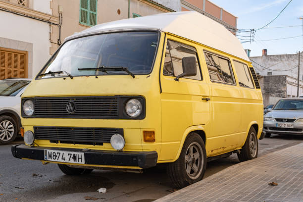 1960s Volkswagen Type 2 (T1) Transporter Kombi or Microbus campervan parked in a field. The Volkswagen Transporter is a popular van to use as a camper and was delivered originally as a camper van, but many have been converted later.