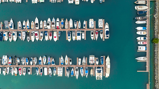 Aerial shot of Burgas pier with sailing boats on it - (Bulgarian: Пристанище Бургас, България с много лодки ). The scene is situated outdoors near noon in Burgas, Bulgaria on the Black Sea shores. The photo is taken with DJI Phantom 4 Pro drone.