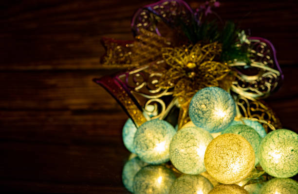 Close up photo of a holiday wreath made of twigs, branches,stars,and christmas ornaments.