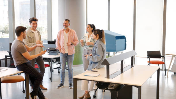 istock Coworkers having a conversation in the office 1454984340