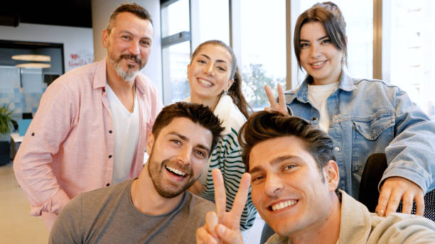 istock Coworkers taking a selfie in the office 1454984386
