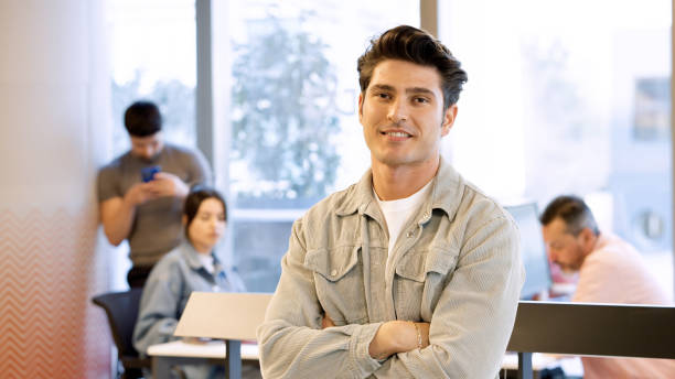 istock Young male entrepreneur posing in a modern office 1454984392