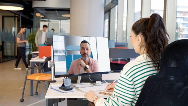 Young woman video conferencing in the office stock photo